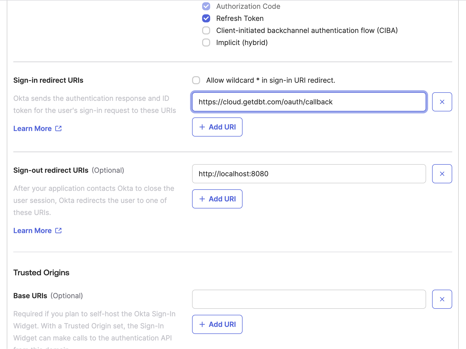 The Okta app configuration window with the sign-in redirect URI configured to the dbt Cloud value